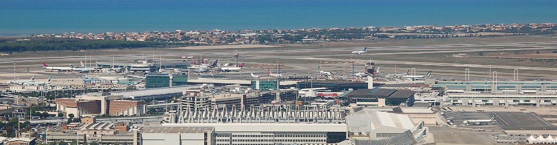 View of Leonardo Da Vinci - Fiumicino Airport, IT across runway at sunset
